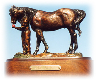 Bronze sculpture of a little girl and her horse.