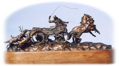 Bronze sculpture of a team and freight wagon.