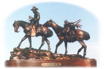 Bronze sculpture of horseback hunter and pack horse.