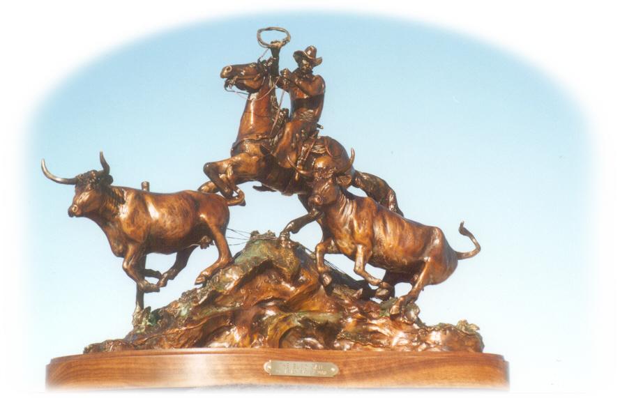 Bronze sculpture of cowboy and cattle.