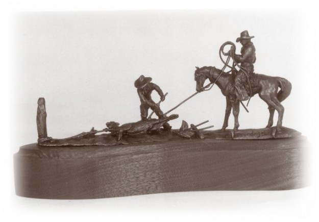 Bronze sculpture of two cowboys, one horseback, branding a calf.