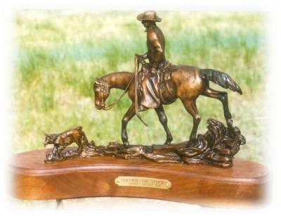 Bronze sculpture of horseback cowboy.