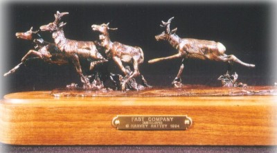 Bronze sculpture of antelope running.