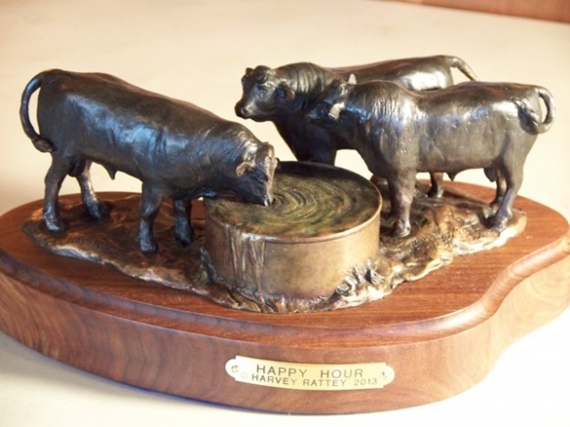 Bronze sculpture of three Angus bulls at the water tank.