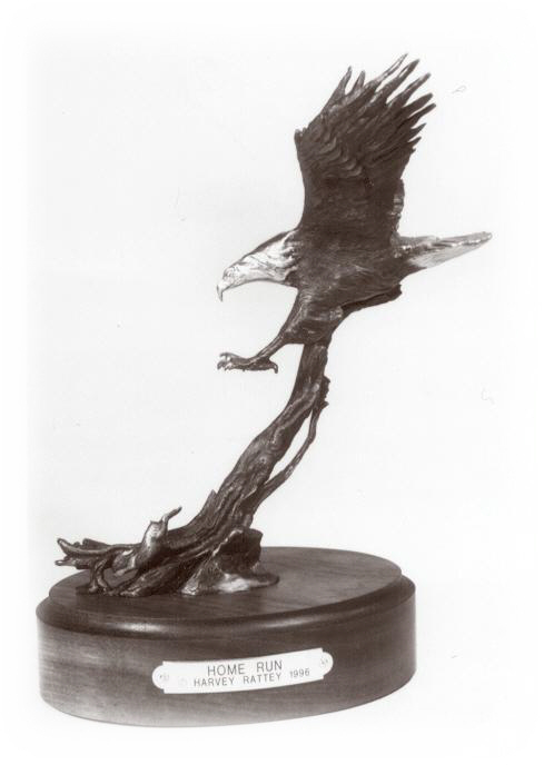 Bronze sculpture of a bald eagle nearly catching a cottontail rabbit.