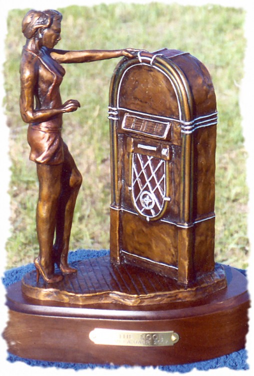 Bronze sculpture of a woman in revealing clothing standing in front of a jukebox.