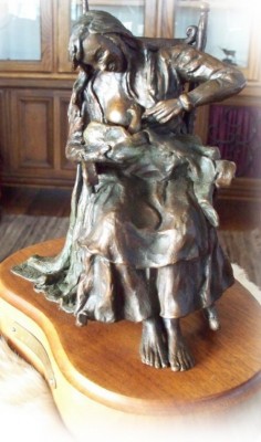 Bronze sculpture of mother and child.