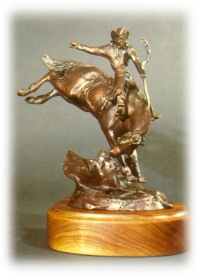 Bronze sculpture of saddle bronc rider.