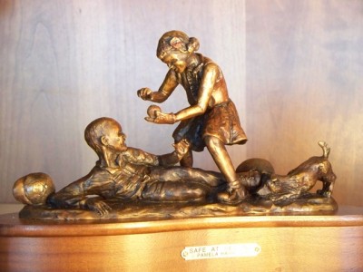 Bronze sculpture of children playing ball.