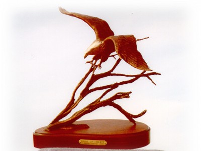 Bronze sculpture of eagle landing.