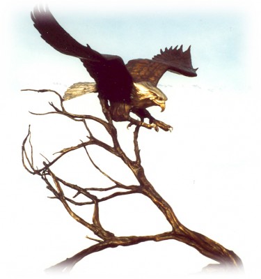 Bronze sculpture of eagle landing in a tree.