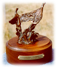 Bronze sculpture of two mallard ducks taking flight.