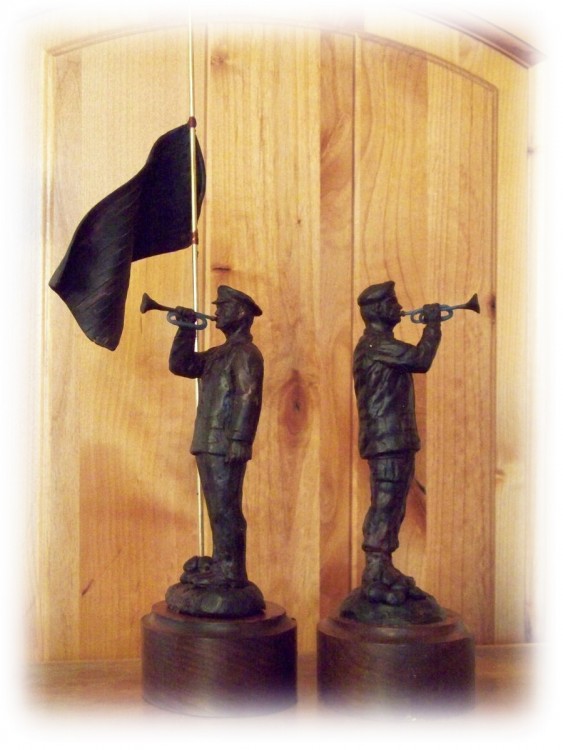 bronze sculptures of American soldier playing the bugle.