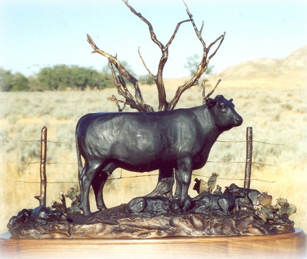 Bronze sculpture of Angus cow and five young calves.