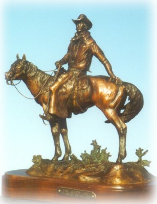 Bronze sculpture of cowboy on his horse.