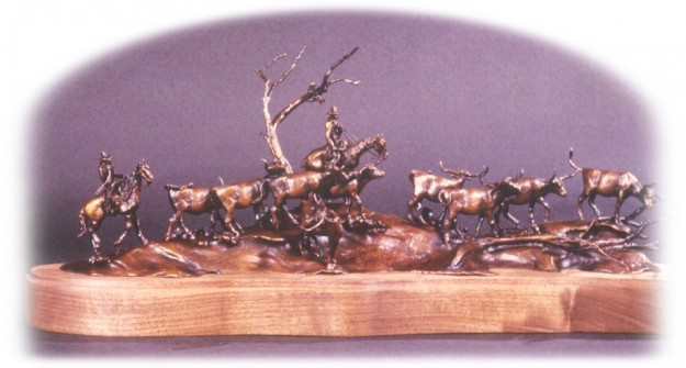 Bronze sculpture of horseback cowboy trailing cattle