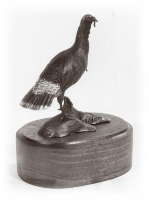 Bronze sculpture of a turkey gobbler.
