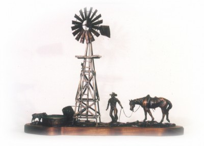 Bronze sculpture of windmill, cowboy and his horse.