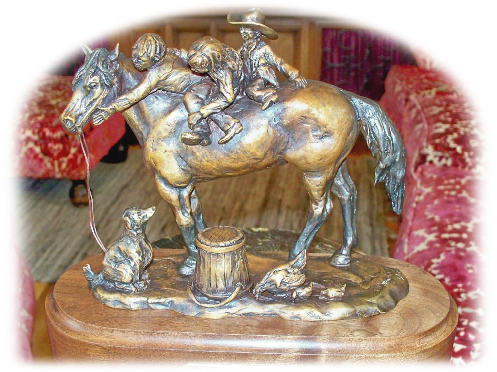 Bronze sculpture of children on a kind horse.
