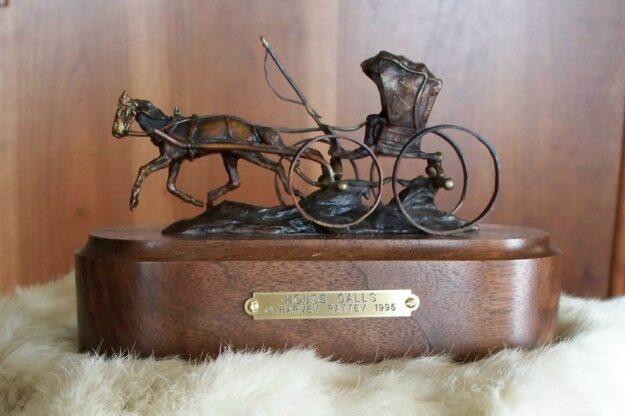 Bronze sculpture of an old time country doctor with his horse and buggy.