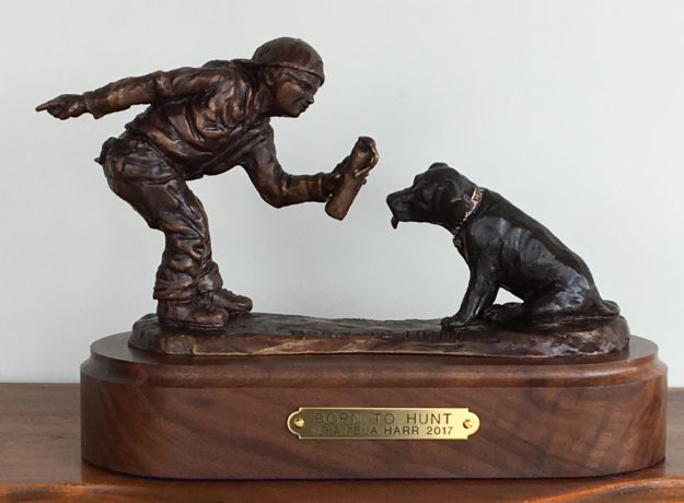 Bronze sculpture of a boy and his Labrador retriever puppy