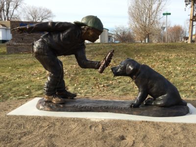 Sculpture of a boy and his dog