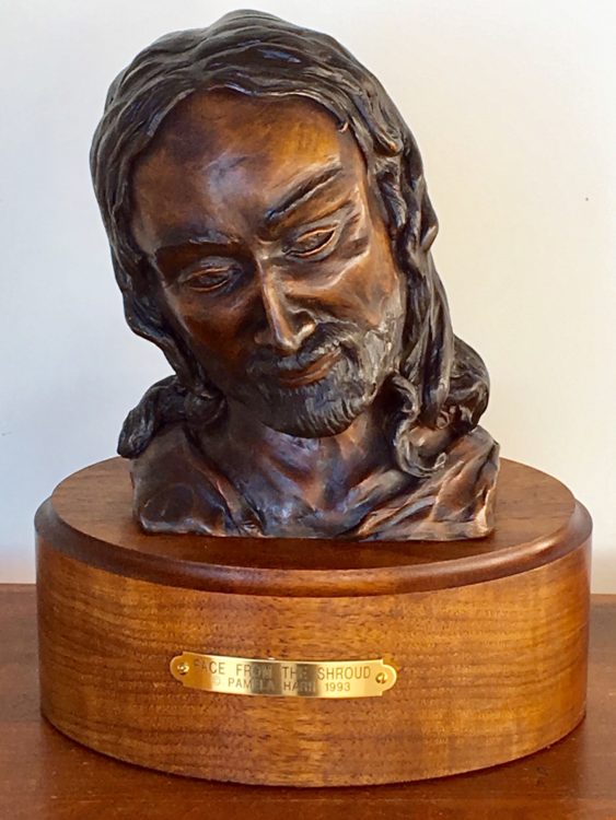 Bronze sculpture of the face of Christ.