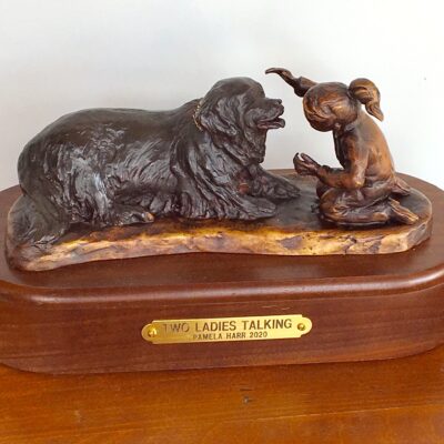 Bronze sculpture of a little girl and her Newfoundland dog