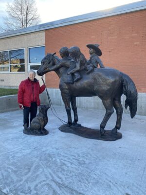Pamala Harr, sculptor, with her newly installed bronze monument "Ground Tied"
