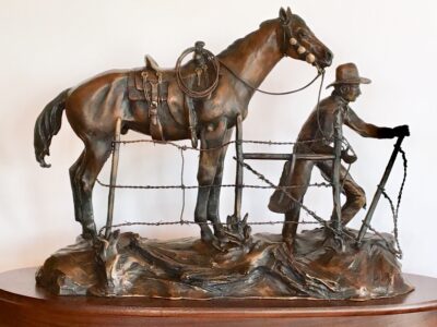 Bronze sculpture of cowboy and his horse