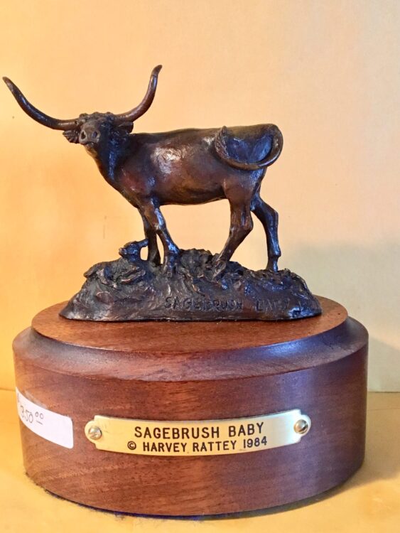 Small bronze sculpture of a longhorn cow and her newborn calf.