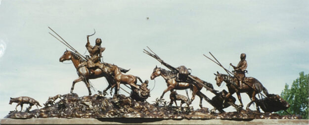 Bronze sculpture of Native Americans moving their homes