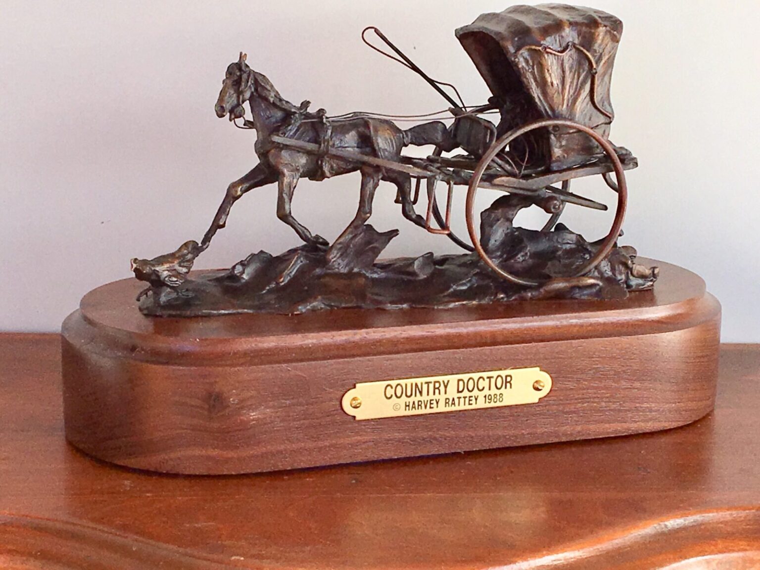 Bronze sculpture of a doctor with his horse and buggy.