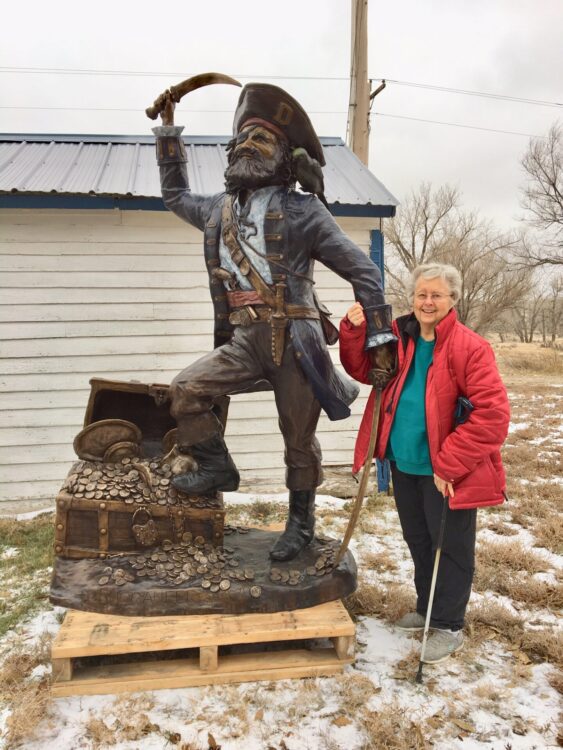 Pam Harr and the Buccaneer schulpture for Dawson Communty College